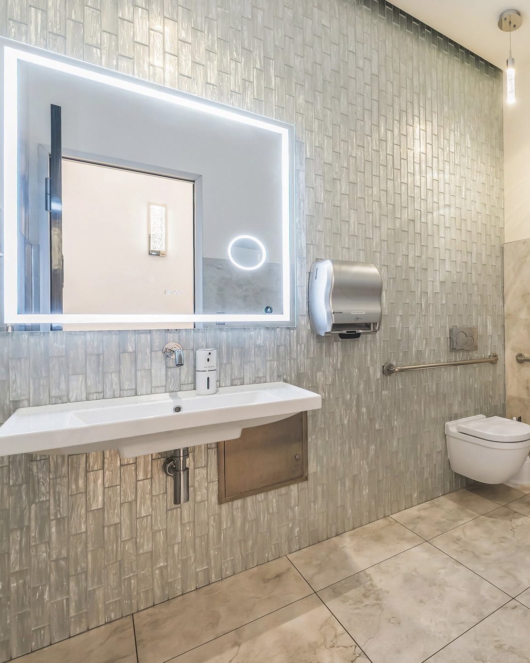 Touchless soap and towel dispensers in bathroom